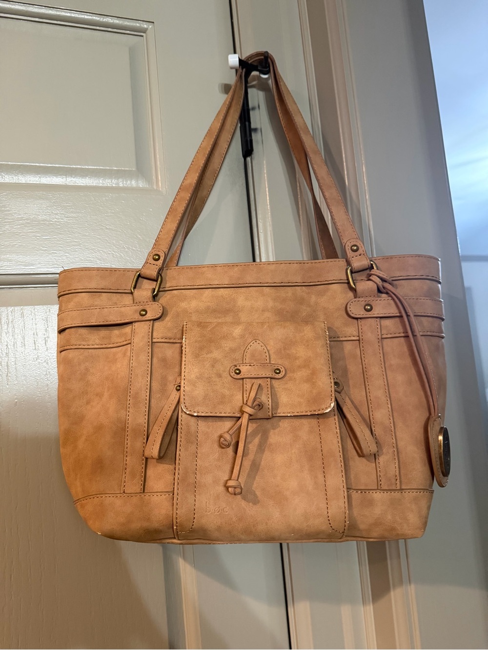 B.O.C Tan tote bag with adjustable straps and multiple pockets